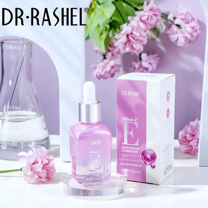 Dr. Rashel Vitamin E serum with packaging box. Dark spots corrector, 30ml, displayed with flowers and laboratory glassware.