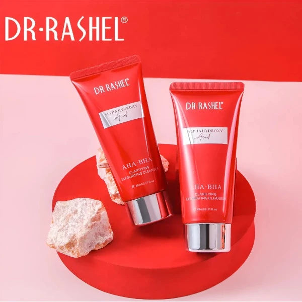 Two tubes of Dr. Rashel AHA-BHA Clarifying Exfoliating Cleanser displayed with vibrant red background.